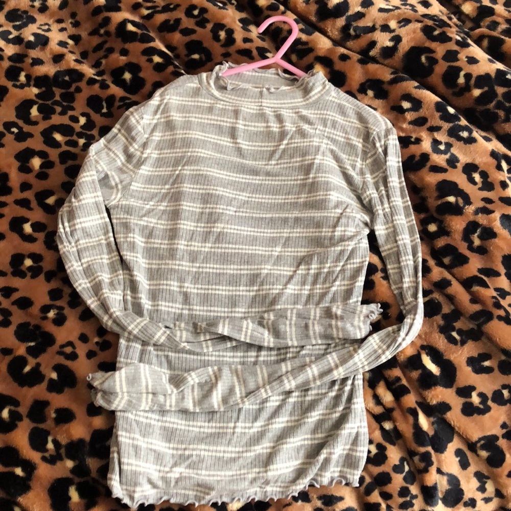 Grey and white turtle neck with curls on ends